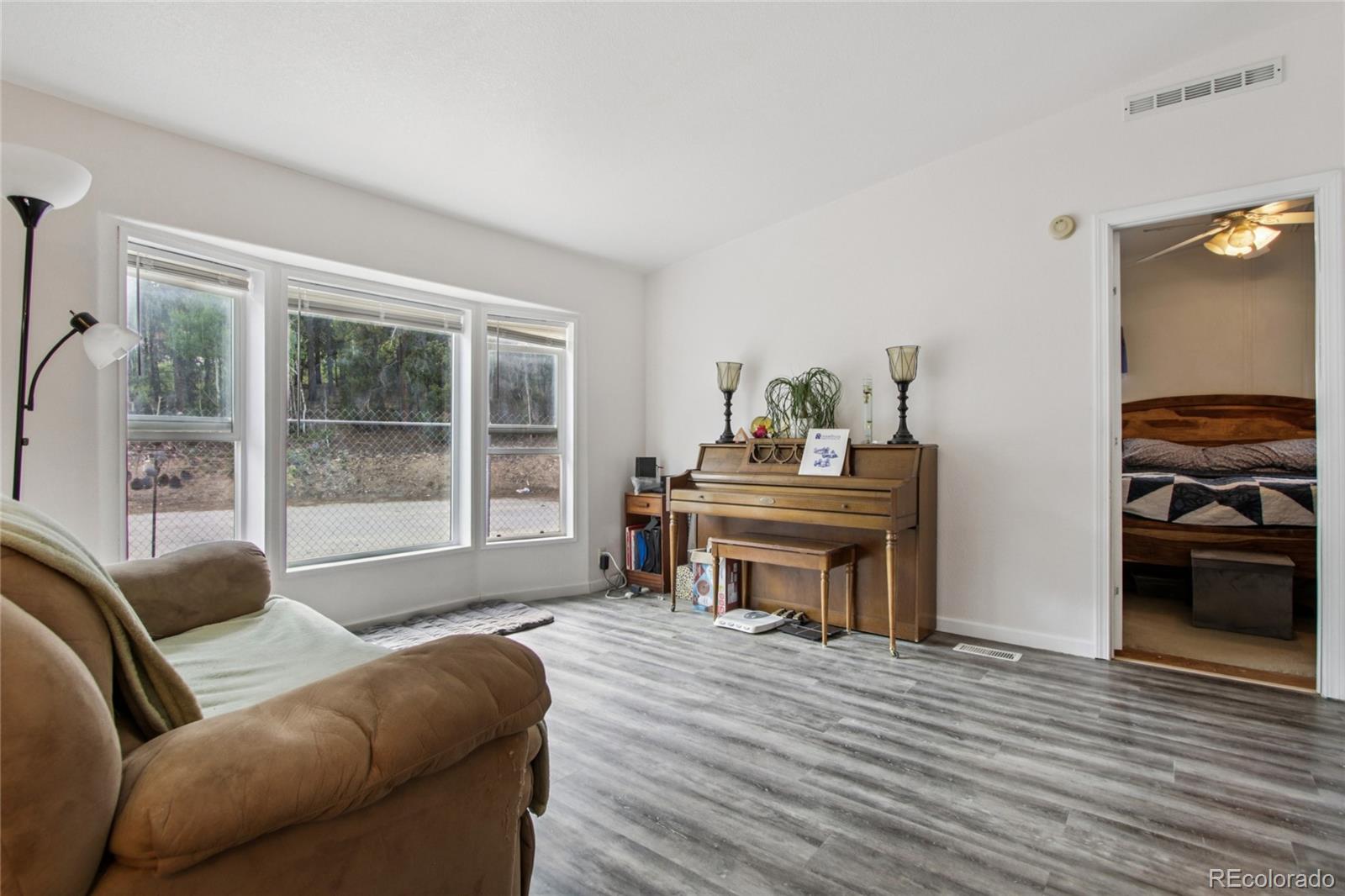 81 Atlantis Road Black Hawk, CO 80422 - Photo 5 of 40 a living room with furniture and a wooden floor
