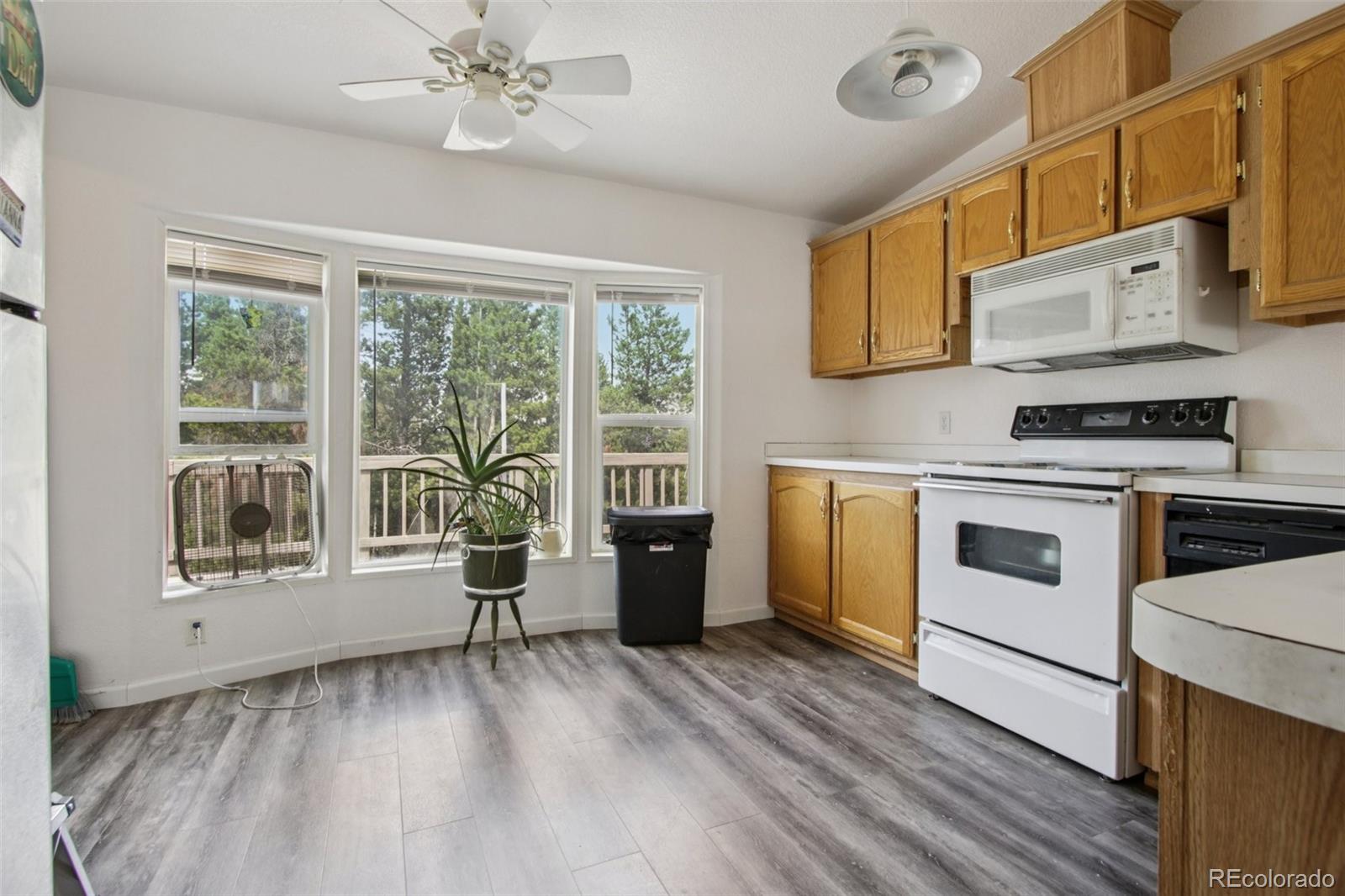 81 Atlantis Road Black Hawk, CO 80422 - Photo 8 of 40 a kitchen with a stove top oven sink and wooden floor