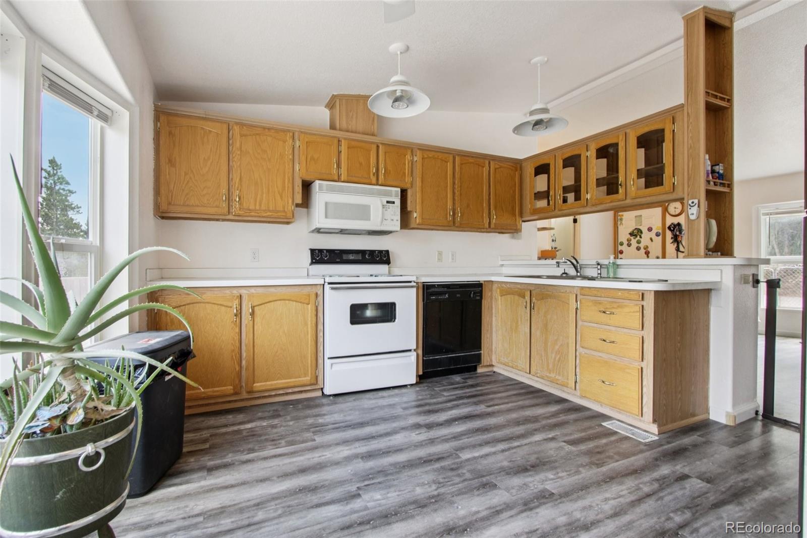 81 Atlantis Road Black Hawk, CO 80422 - Photo 9 of 40 a kitchen with a stove a sink and a refrigerator