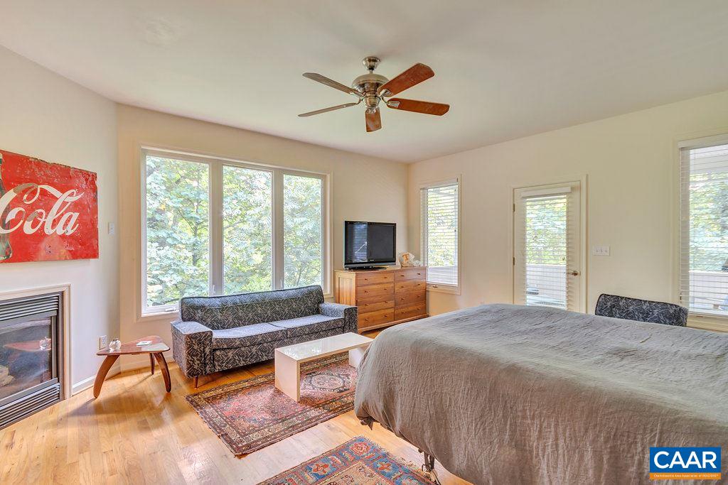741 Dry Bridge Road Charlottesville, VA 22903 - Photo 17 of 37 a spacious bedroom with a bed and a couch