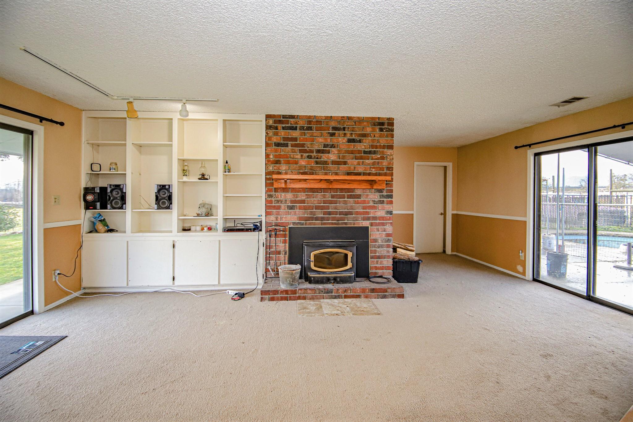 6577 Blackwell Road Central Point, OR 97502 - Photo 6 of 27 a living room with a fireplace furniture and a large window