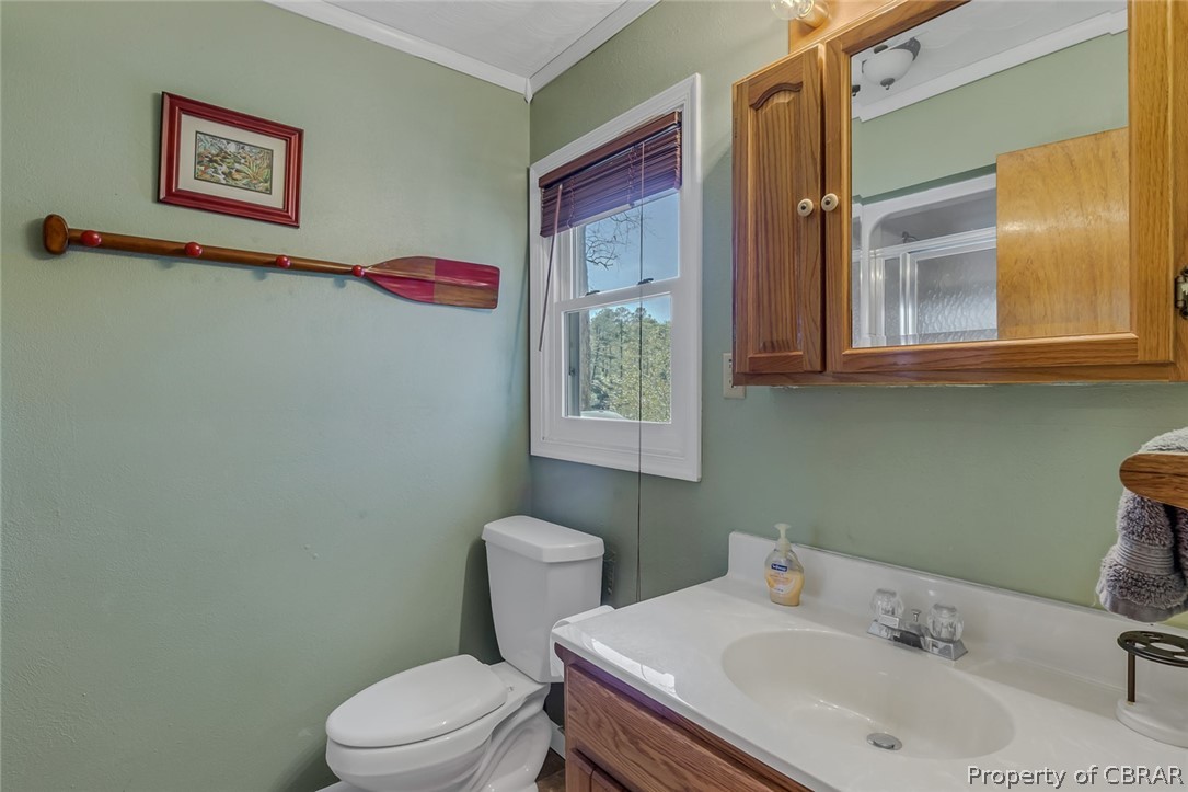 270 Robins Nest Road Lancaster, VA 22503 - Photo 46 of 50 Bathroom featuring crown molding, toilet, and vanity