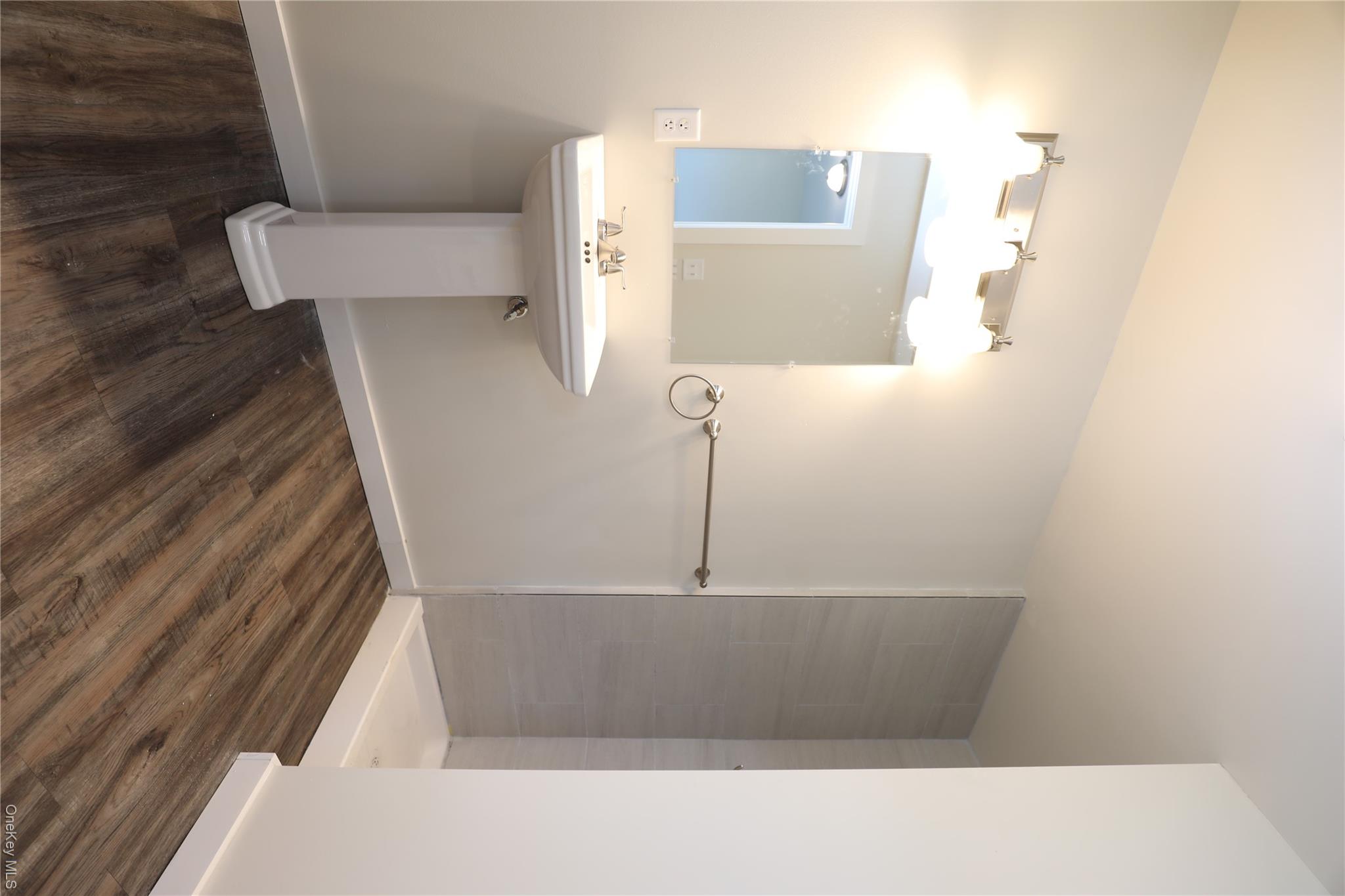 14311 Rte 9W, Unit 2 Ravena, NY 12143 - Photo 5 of 9 a bathroom with a sink toilet and mirror