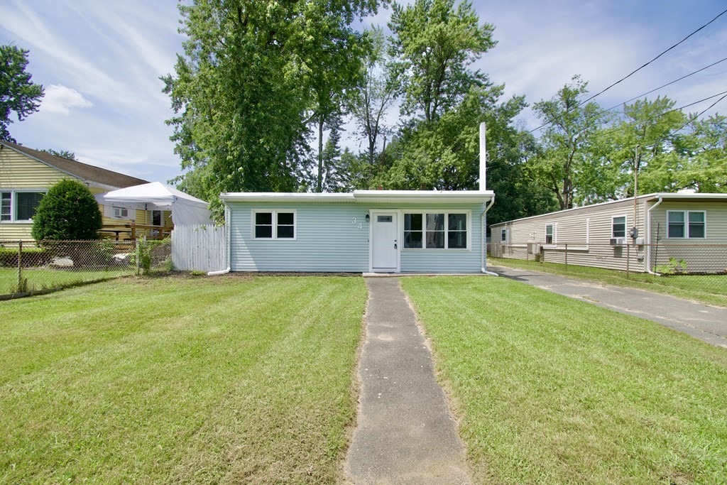 a view of a house with a backyard