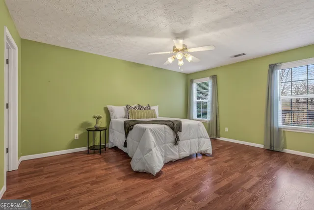a spacious bedroom with a bed and a window