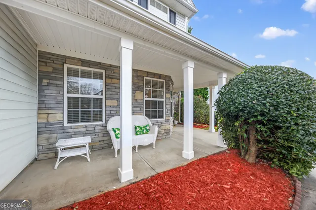 a view of a two chairs in the patio