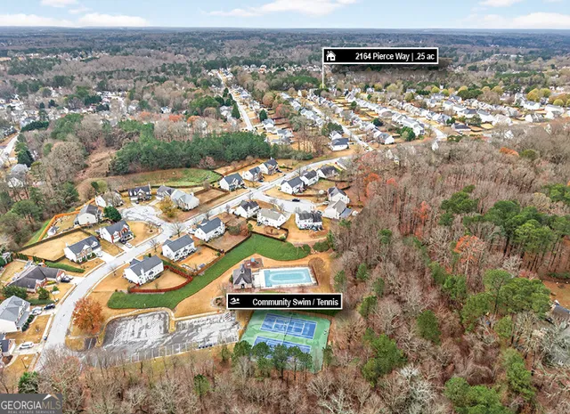an aerial view of residential houses with outdoor space