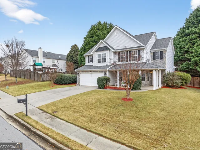 a view of house with swimming pool and sitting area