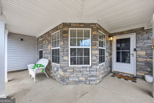 a balcony with table and chairs