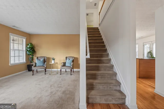 a view of entryway and hall with wooden floor