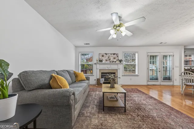 a living room with furniture a chandelier and a fireplace