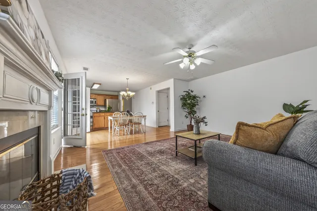 a living room with furniture and a chandelier