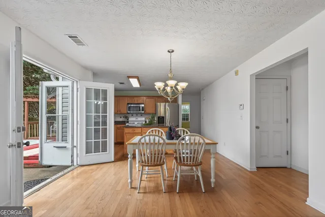 a view of a dining room with furniture window and wooden floor