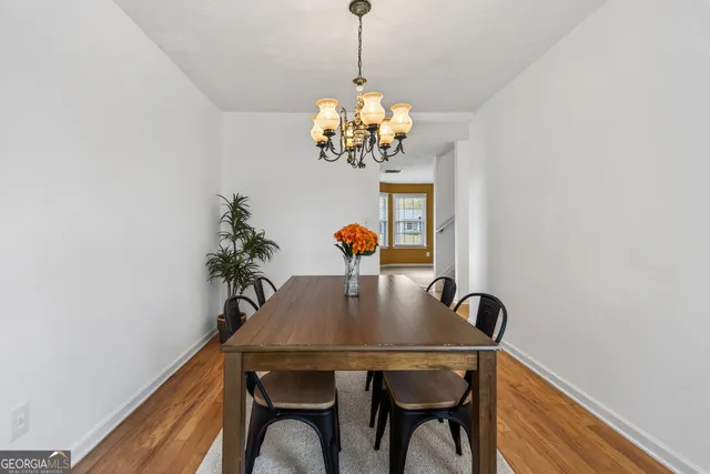 a dining room with furniture and chandelier