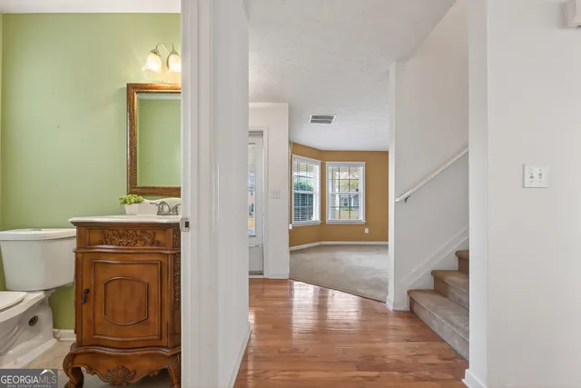 a view of a hallway with wooden floor and a fireplace