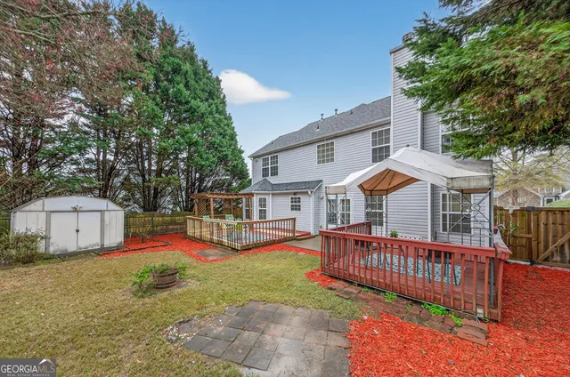 a view of a house with a big yard and large trees