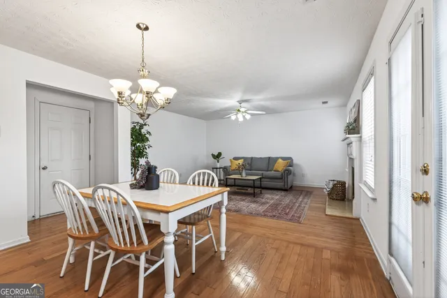 a view of a dining room with furniture wooden floor and chandelier