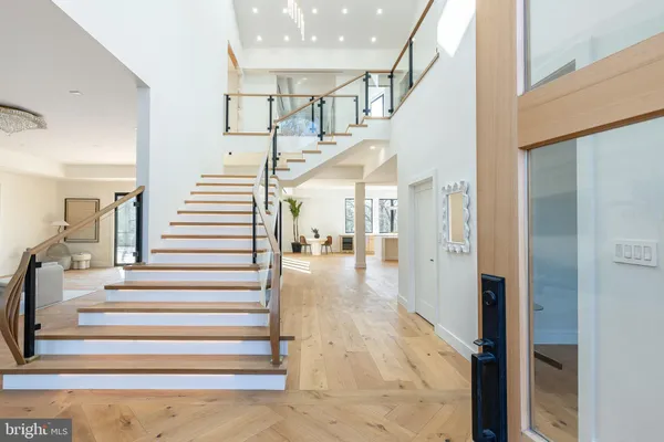 a view of entryway and hall with wooden floor
