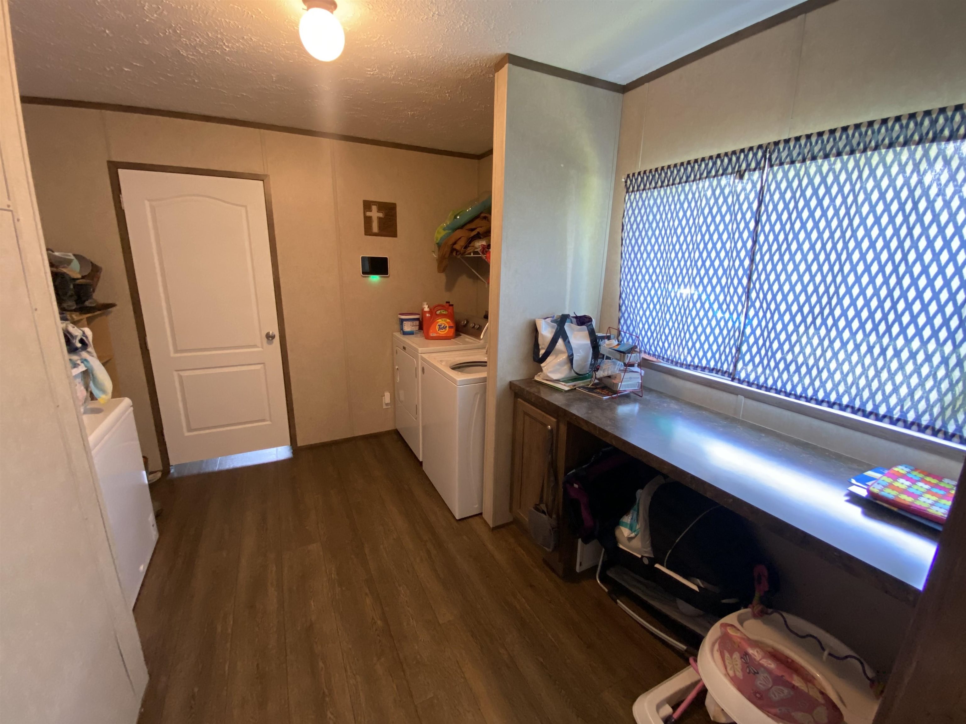 675 Humphrey Road Huntingdon, TN 38344 - Photo 24 of 25 a view of an empty room with wooden floor and a window
