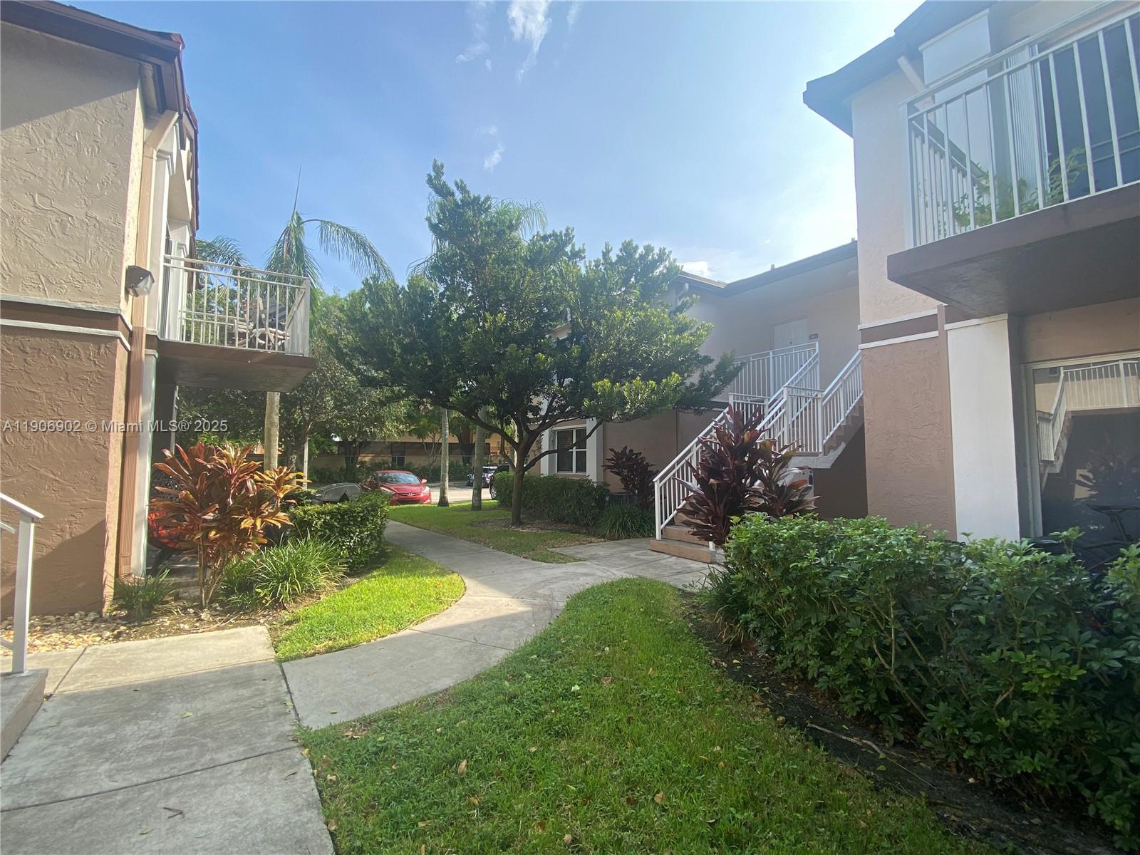 a view of a house with a yard and a garden