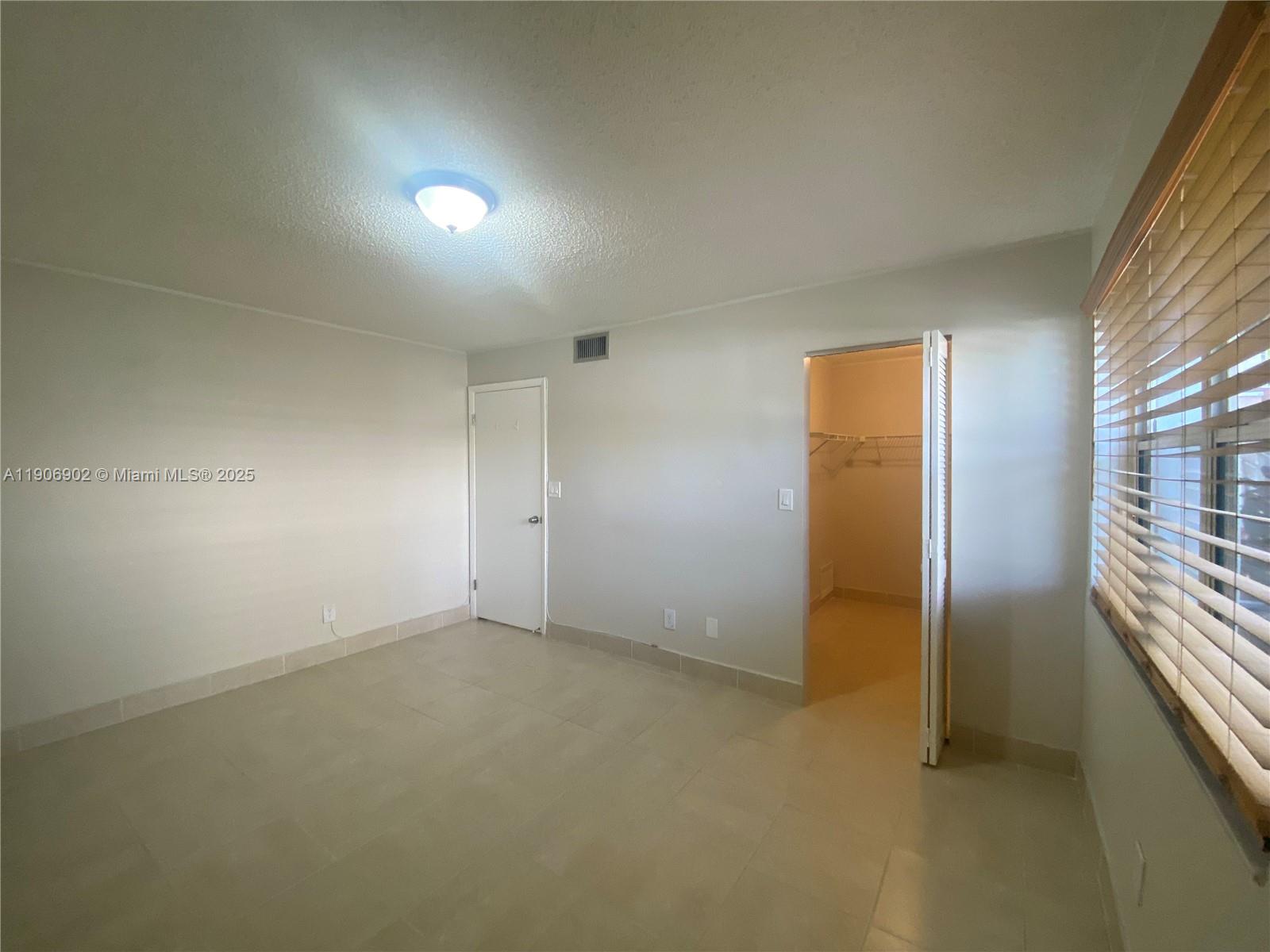 11232 Southwest 12th Street, Unit 101 Pembroke Pines, FL 33025 - Photo 14 of 37 an empty room with windows
