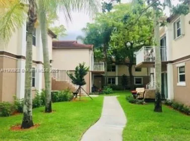 a view of a house with a yard and a garden
