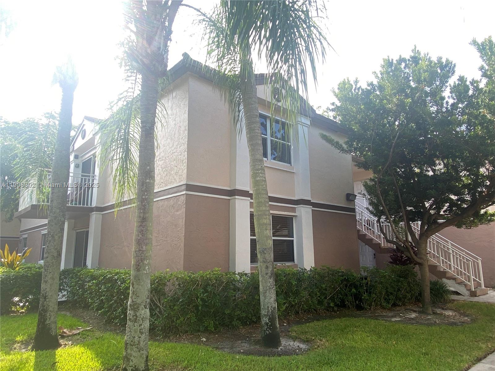 11232 Southwest 12th Street, Unit 101 Pembroke Pines, FL 33025 - Photo 21 of 37 a view of a house with a yard
