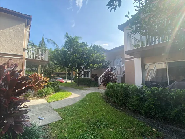 a view of a house with a yard and garden
