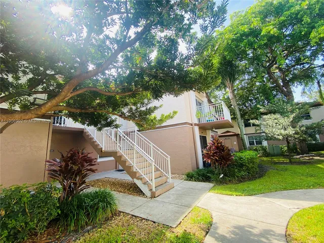 a view of a backyard with plants and a patio