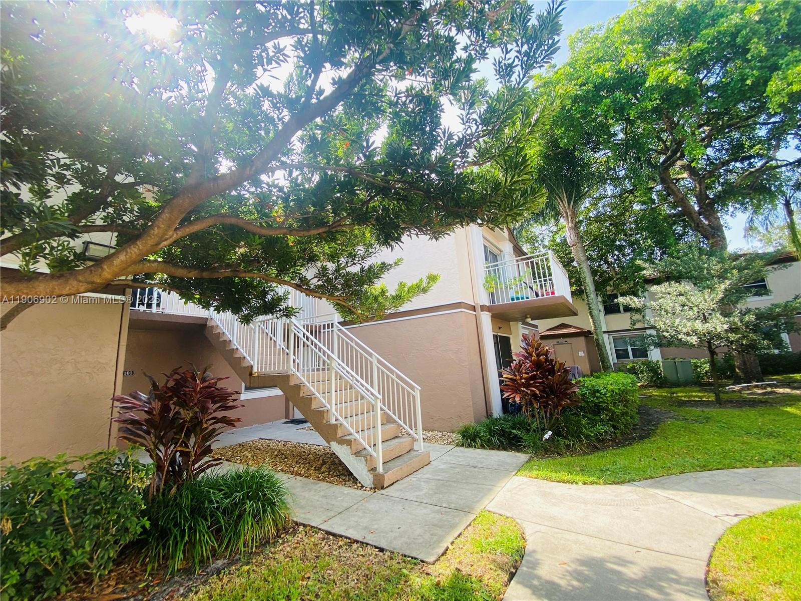 11232 Southwest 12th Street, Unit 101 Pembroke Pines, FL 33025 - Photo 27 of 37 a view of a backyard with plants and a patio