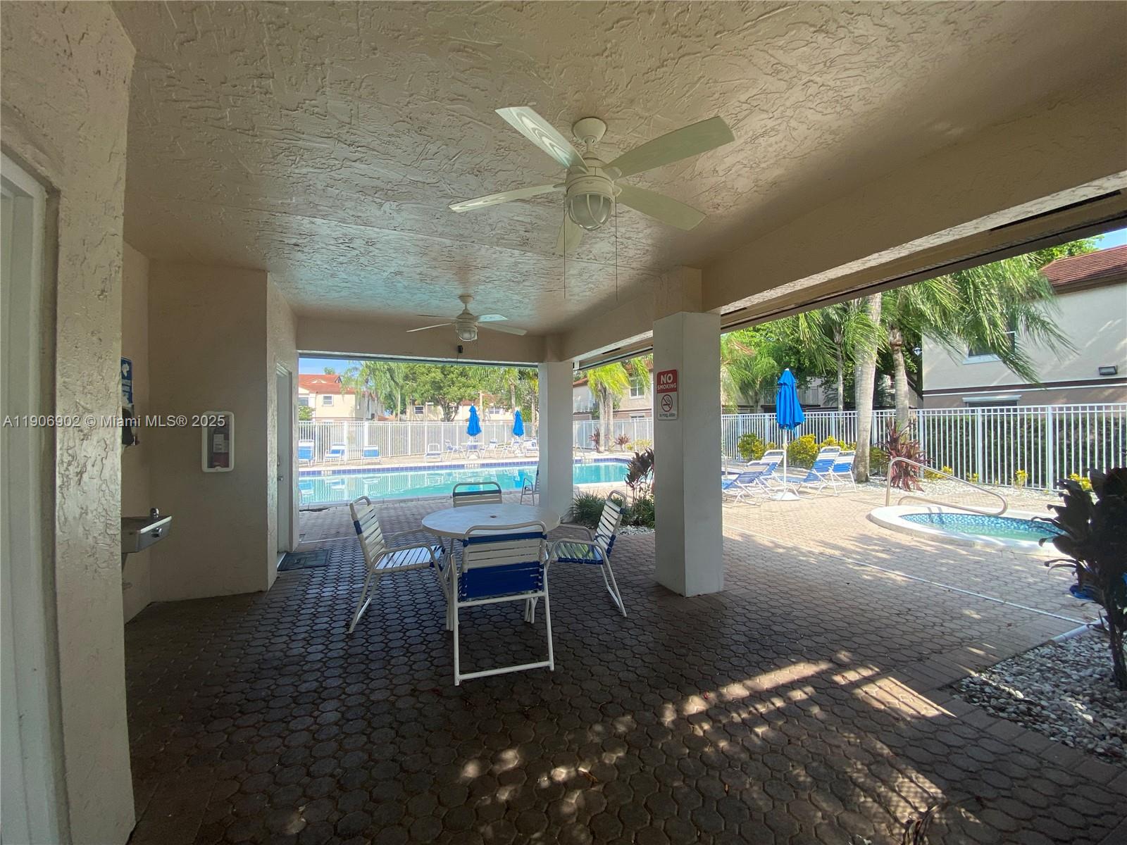 11232 Southwest 12th Street, Unit 101 Pembroke Pines, FL 33025 - Photo 32 of 37 a view of a porch with chairs and backyard