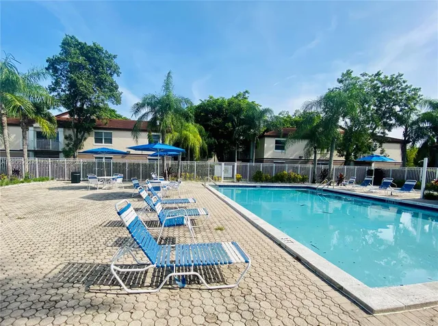 a view of a swimming pool with chairs