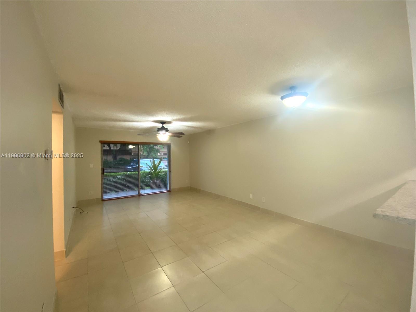 11232 Southwest 12th Street, Unit 101 Pembroke Pines, FL 33025 - Photo 7 of 37 a view of an empty room with a fireplace