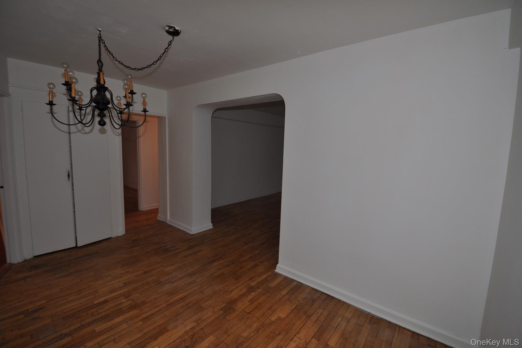 142 Garth Road, Unit 1R Scarsdale, NY 10583 - Photo 5 of 12 a view of a room with wooden floor and ceiling fan