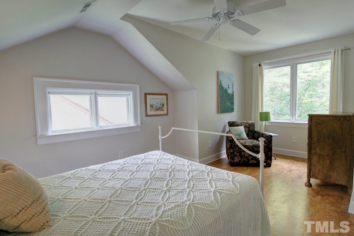 500 Harvey Street Raleigh, NC 27608 - Photo 14 of 26 a bedroom with a bed and a chair