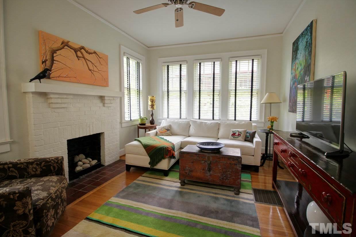 500 Harvey Street Raleigh, NC 27608 - Photo 3 of 26 a living room with furniture large window and a fireplace