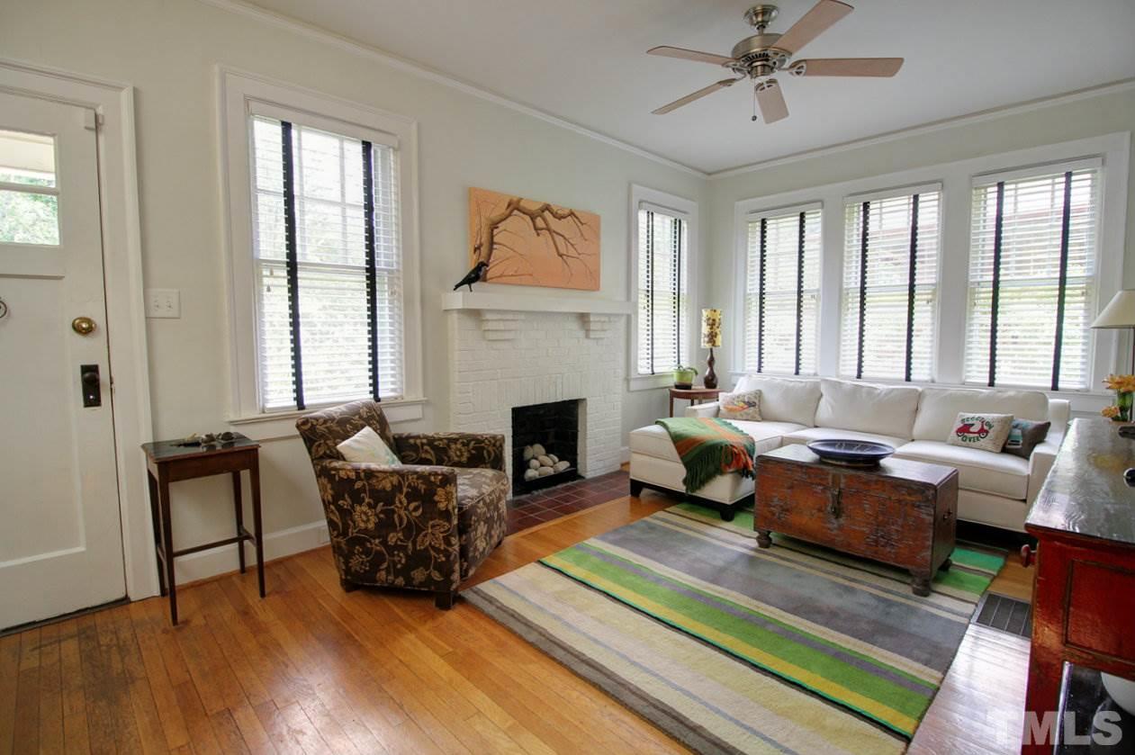 500 Harvey Street Raleigh, NC 27608 - Photo 4 of 26 a living room with furniture large window and a fireplace