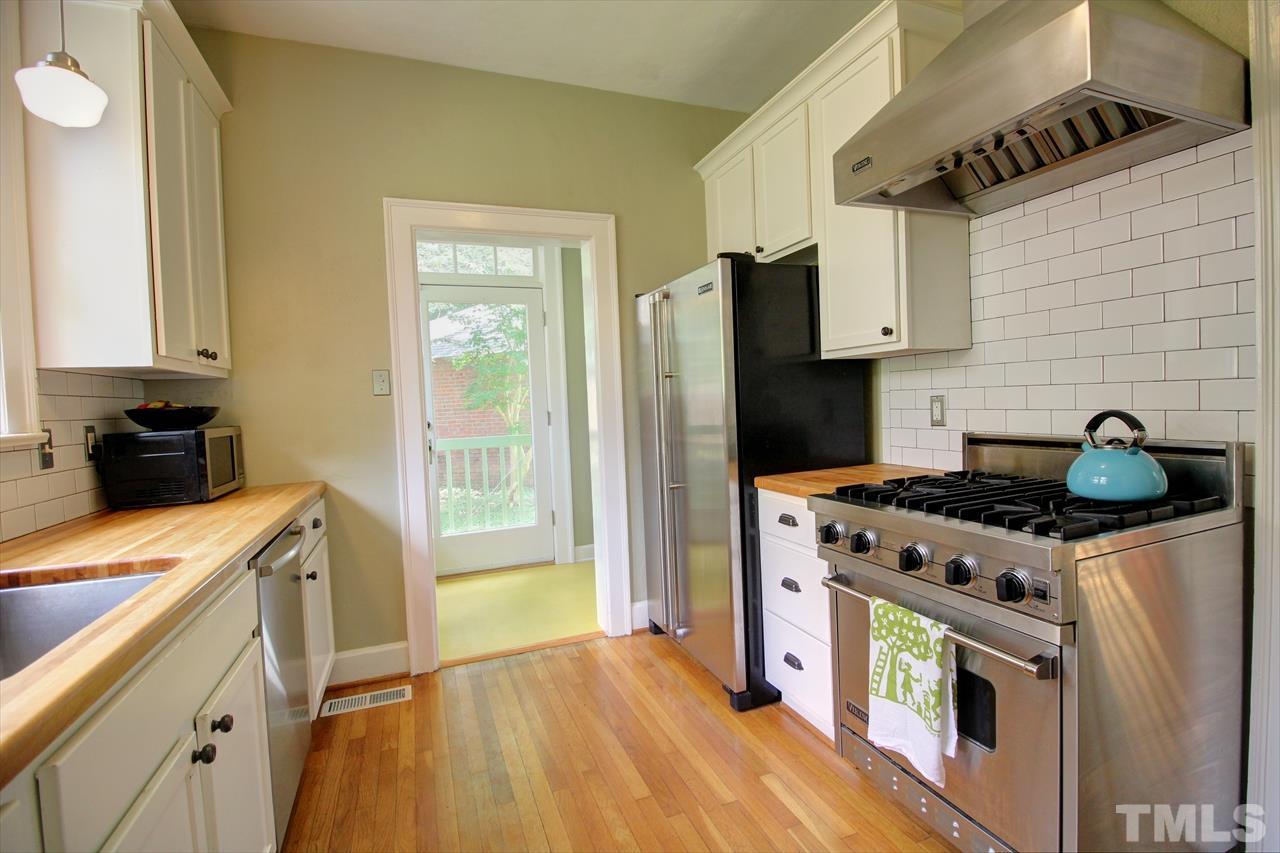500 Harvey Street Raleigh, NC 27608 - Photo 5 of 26 a kitchen with stainless steel appliances granite countertop a stove and a refrigerator