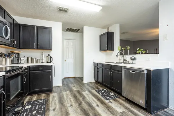 a kitchen with a sink stove and refrigerator