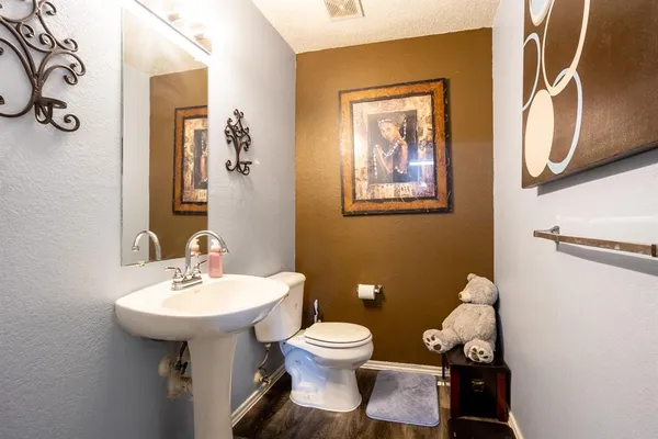 a bathroom with a toilet sink and mirror