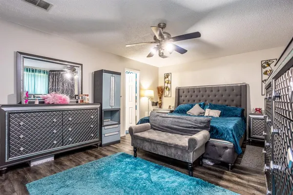 a bedroom with a bed window and dresser