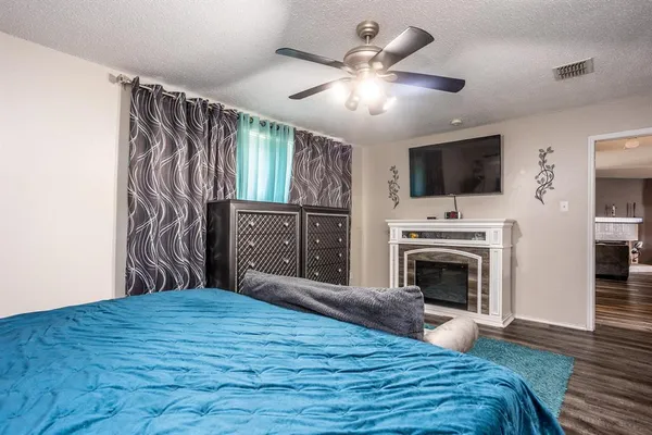 a bedroom with a large bed and a flat screen tv