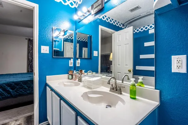 a bathroom with a sink vanity and a mirror