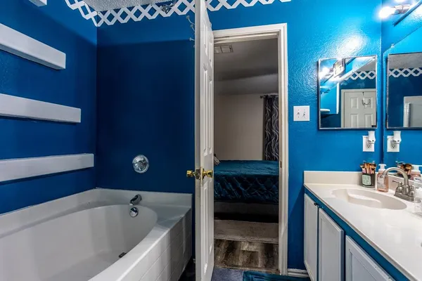 a bathroom with a bathtub and a sink
