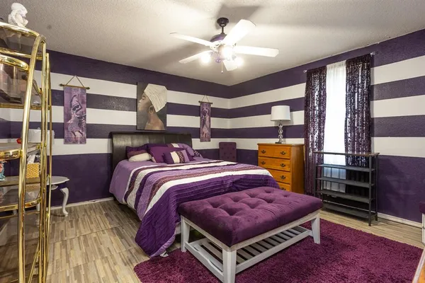 a bed room with a bed and a chandelier