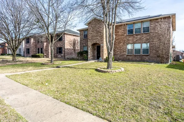 a view of a brick house with a yard