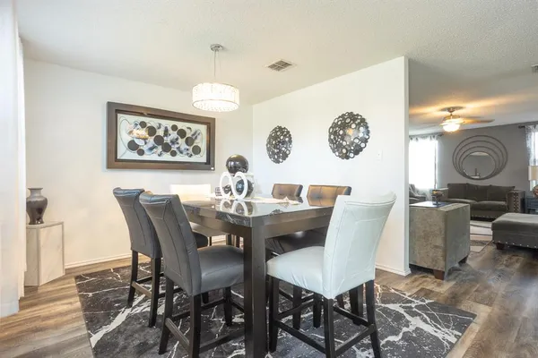 a view of a dining room with furniture and wooden floor