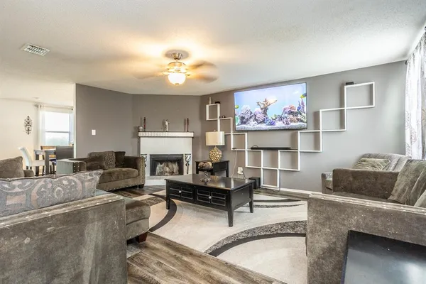 a living room with furniture and a fireplace