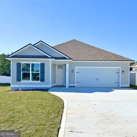 a front view of a house with a yard
