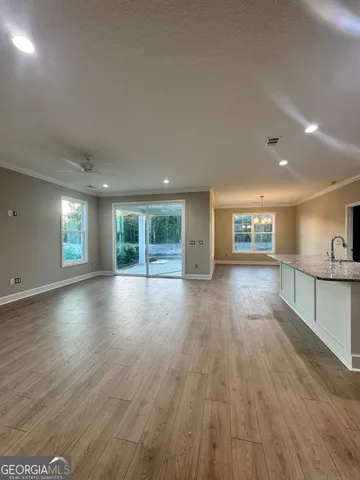 a large kitchen with stainless steel appliances granite countertop a stove and a sink
